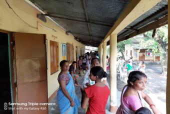 A crowd waits for relief supplies to arrive